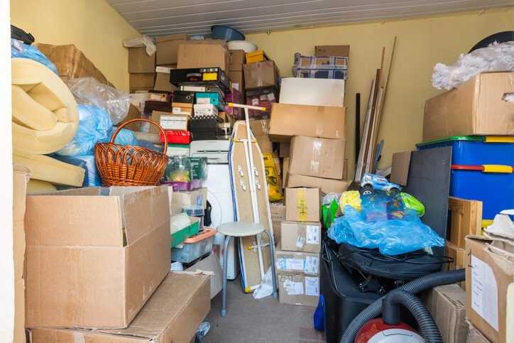 Cluttered garage filled with storage boxes and junk ready for cleanout service in Fort Lauderdale